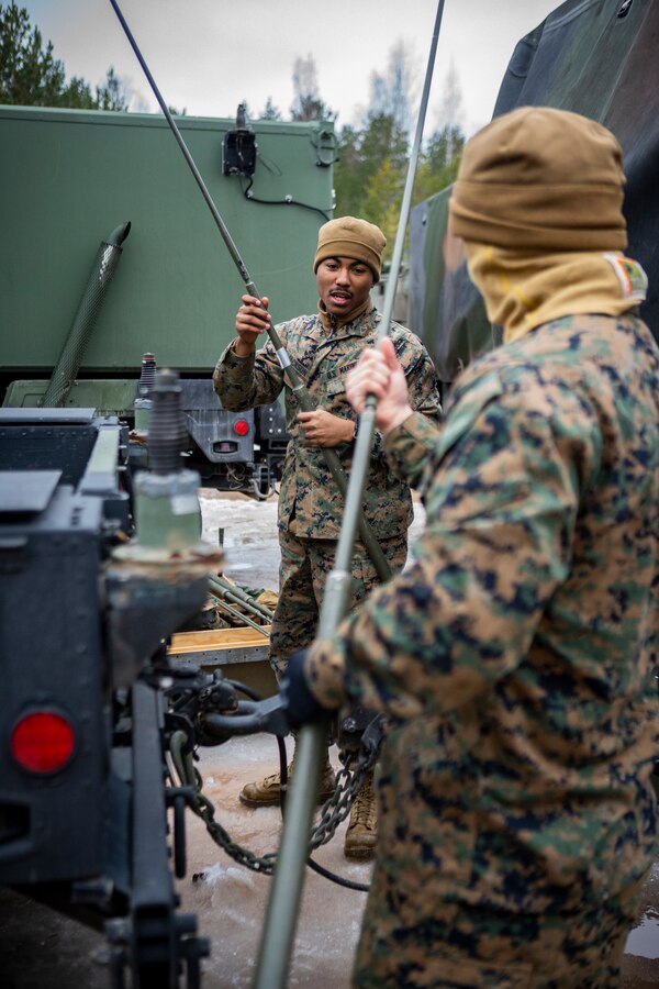 Marines with Hotel Company, 3rd Battalion, 14th Marine Regiment, 4th Marine Division insert antennas onto a humvee in preparation of exercise Dynamic Front 19 at the Adazi Training Area, Latvia, Feb. 26, 2019. The live-fire portion of DF19 will take place March 2-9, 2019, at the Grafenwoehr Training Area, Germany; Riga, Latvia; and Torun, Poland. (U.S. Marine Corps photo by Sgt. Andy O. Martinez)