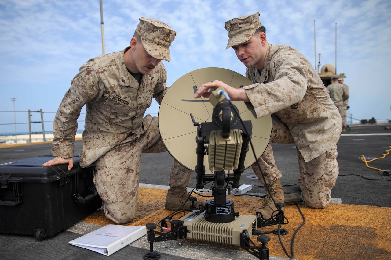 Marines look at satellite dish