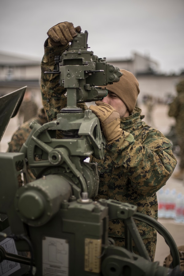 A Marine with Hotel Battery, 3rd Battalion, 14th Marine Regiment, 4th Marine Division inspects a M777 Howitzer at an Adazi Training Area, Latvia, Feb. 26, 2019, during exercise Dynamic Front 19. DF19 is a multinational exercise designed to improve allied and partner nation ability to deliver long-range fires capabilities. (U.S. Marine Corps photo by Cpl. Niles Lee)
