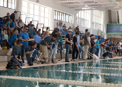 Naval Surface Warfare Center Panama City Division Engineers Tien Le, Ludger Denis, Trent Fruhwirth, and Jessica Morgan keep time and score the SeaPerch teams.