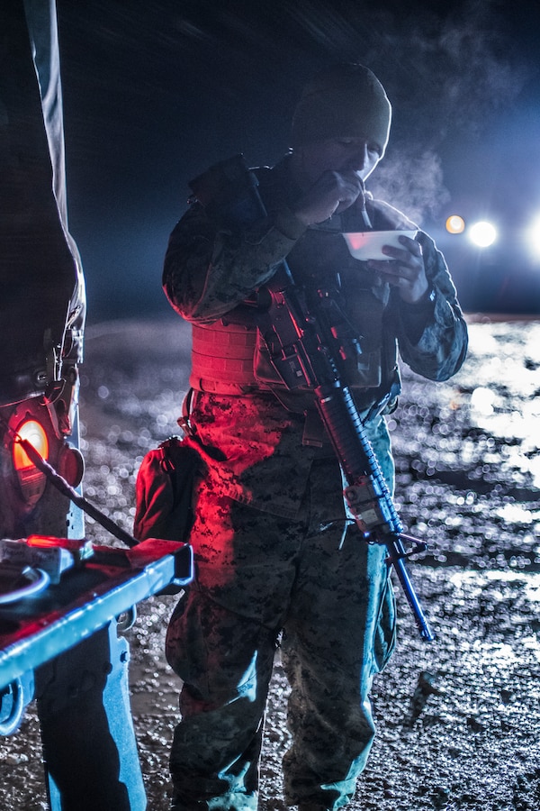 Cpl. Coello Francisco, a motor transportation mechanic with Headquarters Battery, 14th Marine Regiment, 4th Marine Division, eats a hot meal at a motor pool in Adazi Training Area, Latvia, Feb. 27, 2019, during exercise Dynamic Front 19. Exercise Dynamic Front 19 includes approximately 3,200 service members from 27 nations who are observing or participating from Grafenwoehr Training Area, Germany; Riga, Latvia; and Torun, Poland; during March 2-9, 2019. Dynamic Front is an annual U.S. Army Europe exercise focused on the readiness and interoperability of U.S. Army, joint service, and allied and partner nations’ artillery and fire support working together in a multinational environment. (U.S. Marine Corps photo by Cpl. Niles Lee)