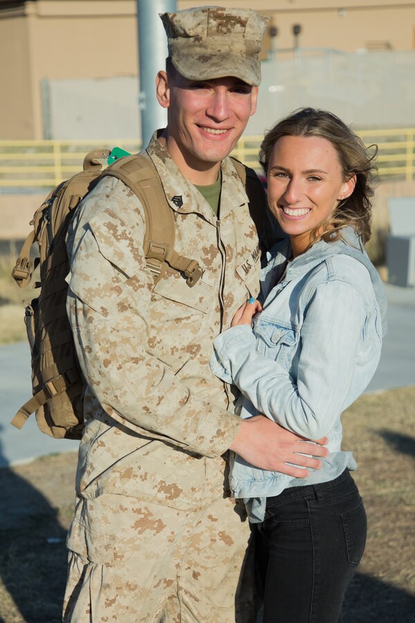 U.S. Marine Sgt. Dakota Tinney, administrative specialist, 3rd Battalion, 4th Marine Regiment, 1st Marine Division, and Amber Tronti, Tinney’s significant other, pose for a photo during the battalion’s homecoming ceremony at Victory Field on Marine Corps Air Ground Combat Center (MCAGCC), Twentynine Palms, Calif. March 8, 2019. The Marines and sailors returned from a six-month deployment to Kuwait. (U.S. Marine Corps photo by Pfc. Shane T. Beaubien)