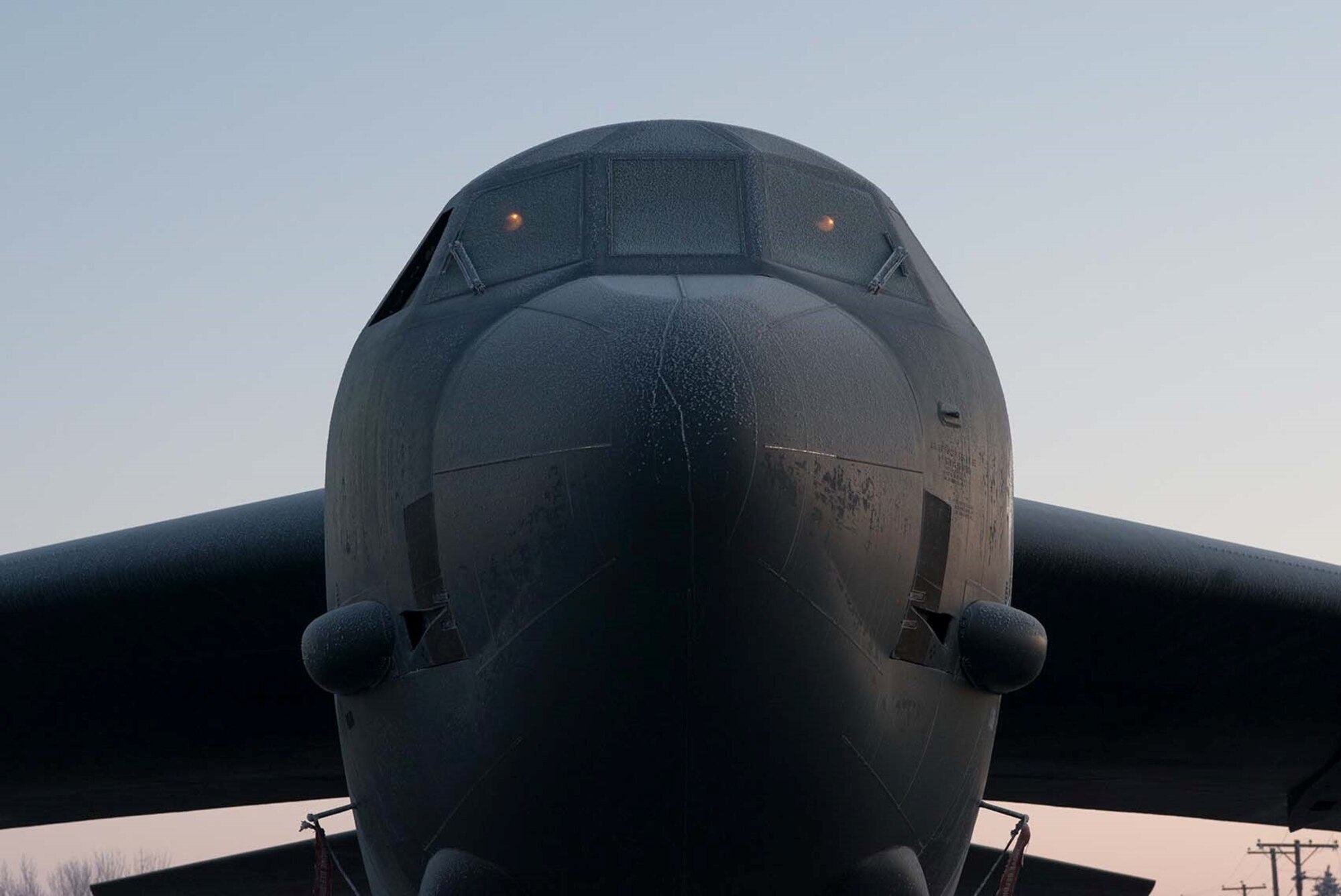 The B-52H Stratofortress slowly thaws as the sun rises at Minot Air Force Base, North Dakota, March 11, 2019. The B-52 is capable of carrying up to 70,000 pounds of munitions and is mission ready 24/7. (U.S. Air Force photo by Airman Jesse Jenny)