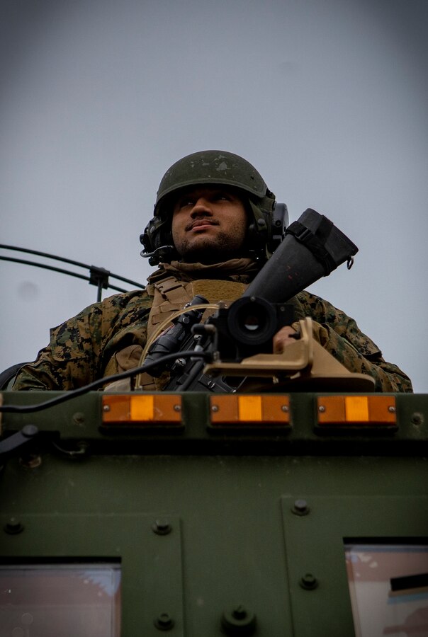 A U.S. Marine with Fox Battery, 2nd Battalion, 14th Marine Regiment, 4th Marine Division, guards a High Mobility Artillery Rocket System during live-fire training at Adazi Training Area, Latvia, March 7, 2019, in support of exercise Dynamic Front 19. Exercise Dynamic Front 19 includes approximately 3,200 service members from 27 nations who are observing or participating from Grafenwoehr Training Area, Germany; Riga, Latvia; and Torun, Poland; during March 2-9, 2019. Dynamic Front is an annual U.S. Army Europe exercise focused on the readiness and interoperability of U.S. Army, joint service, and allied and partner nations’ artillery and fire support working together in a multinational environment. (U.S. Marine Corps photo by Sgt. Andy O. Martinez)