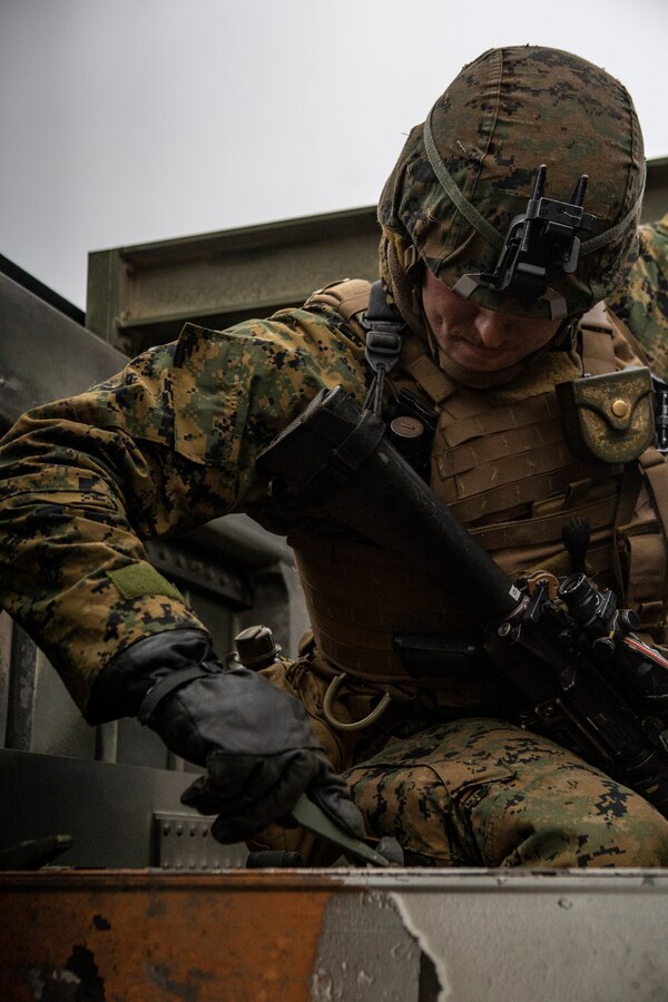 A U.S. Marine with Fox Battery, 2nd Battalion, 14th Marine Regiment, 4th Marine Division, scrapes off rocket exhaust during live-fire training at Adazi Training Area, Latvia, March 7, 2019, in support of exercise Dynamic Front 19. Exercise Dynamic Front 19 includes approximately 3,200 service members from 27 nations who are observing or participating from Grafenwoehr Training Area, Germany; Riga, Latvia; and Torun, Poland; during March 2-9, 2019. Dynamic Front is an annual U.S. Army Europe exercise focused on the readiness and interoperability of U.S. Army, joint service, and allied and partner nations’ artillery and fire support working together in a multinational environment. (U.S. Marine Corps photo by Sgt. Andy O. Martinez)