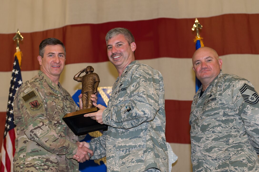 Lt. Col. Thane Sisson, 23d Maintenance Squadron (MXS), accepts the Lt. Gen. Leo Marquez Award on behalf of Tech. Sgt. Alan Stephenson, 23d MXS, March 8, 2019, at Moody Air Force Base, Ga. Stephenson won this award for the NCO in Aircraft Maintenance category. Maintenance Professional of the Year (MPOY) is a long-running tradition in the maintenance career field. MPOY is a ceremony that highlights that year's top performing Airmen. (U.S. Air Force photo by Airman 1st Class Hayden Legg)