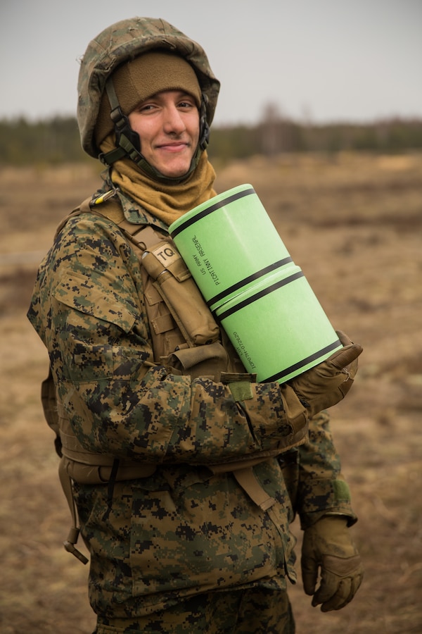 U.S. Marine Corps Pfc. Charles Ionadi, a field artillery cannoneer with Hotel Battery 14th Marine Regiment, 4th Marine Division, holds an M777 powder charge during a live-fire exercise at Adazi Training Area, Latvia, March 7, 2019, in support of exercise Dynamic Front 19. Exercise Dynamic Front 19 includes approximately 3,200 service members from 27 nations who are observing or participating from Grafenwoehr Training Area, Germany; Riga, Latvia; and Torun, Poland; during March 2-9, 2019. Dynamic Front is an annual U.S. Army Europe exercise focused on the readiness and interoperability of U.S. Army, joint service, and allied and partner nations’ artillery and fire support working together in a multinational environment. (U.S. Marine Corps photo by Lance Cpl. Faeth E. Webb)
