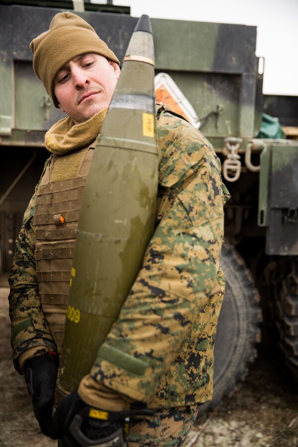U.S. Marine Corps Cpl. John R. Garbo, a field artillery cannoneer with Hotel Battery, 14th Marine Regiment, 4th Marine Division, carries an M777 howitzer round during live-fire training at Adazi Training Area, Latvia, March 7, 2019, in support of exercise Dynamic Front 19. Exercise Dynamic Front 19 includes approximately 3,200 service members from 27 nations who are observing or participating from Grafenwoehr Training Area, Germany; Riga, Latvia; and Torun, Poland; during March 2-9, 2019. Dynamic Front is an annual U.S. Army Europe exercise focused on the readiness and interoperability of U.S. Army, joint service, and allied and partner nations’ artillery and fire support working together in a multinational environment. (U.S. Marine Corps photo by Lance Cpl. Faeth E. Webb)