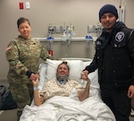 Staff Sgt. Tina Spencer (left), 717th Military Intelligence Battalion platoon sergeant at Joint Base San Antonio-Lackland, and Tre Pena (right), stand beside Tiffany Kieschnick-Rivas in her hospital bed. Kieschnick-Rivas was involved in a vehicle accident Jan. 30 in northwest San Antonio in which her car flipped over on its side in a drainage ditch. Spencer and Pena provided assistance to Kieschnick-Rivas at the accident scene before paramedics arrived, helping to save her life.