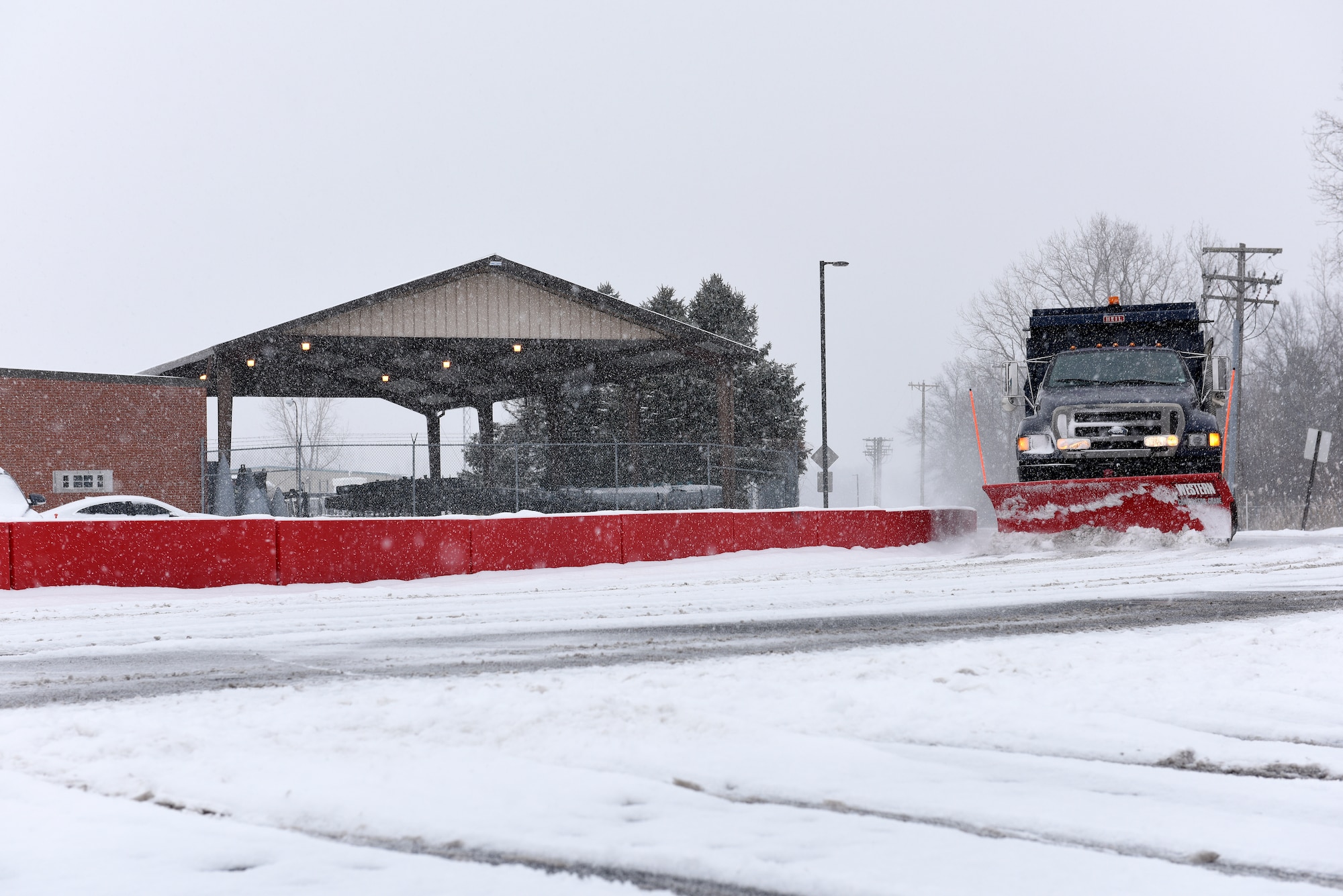 A plow removes snow and ice from the roads at the 180th Fighter Wing, Ohio Air National Guard during a polar vortex Jan. 28, 2019. Snow removal is a critical aspect of ensuring base personnel remain safe. (U.S. Air National Guard photo by Staff Sgt. Shane Hughes)
