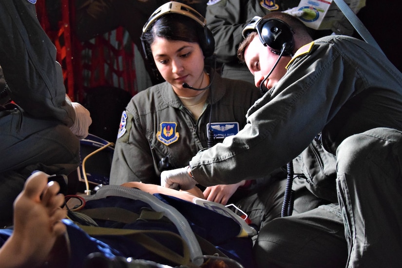 Two airmen tend to a patient.