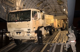 Staff Sgt. Nicholas Ingenthron, operations non commissioned officer, 1st Theater Sustainment Command, (TSC) backs a M1078 Light Medium Tactical Vehicle and trailer into a C-130 aircraft Feb. 10, 2019 at the Louisville International Airport. The vehicle, along with other equipment in the Early Entry Command Post’s first force package, traveled by air to Fort Campbell, Ky. (U.S. Army photo by Master Sgt. Jonathan Wiley)