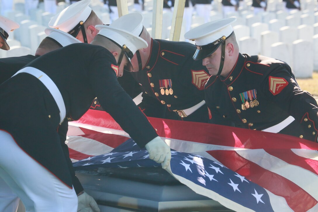 Marine Corps Body Bearers, Bravo Company, Marine Barracks Washington D.C., prepare to fold the National Flag during a full honors funeral for Lt. Gen. Leo Dulacki at Arlington National Cemetery, Arlington, Virginia, March 13, 2019. Dulacki enlisted in the Marine Corps in 1941 and received his commission as a second lieutenant on Sept. 2, 1941. During his 32 years of service, Dulacki fought in World War II, Korea and Vietnam; he retired in January 1974. His personal decorations included the Distinguished Service Medal with a gold star, Legion of Merit with a combat distinguishing device for valor with three gold stars, and the Purple Heart. Dulacki passed away on Jan. 4, 2019 six days after his 100th birthday. (U.S. Marine Corps photo by Sgt. Robert Knapp/Released)