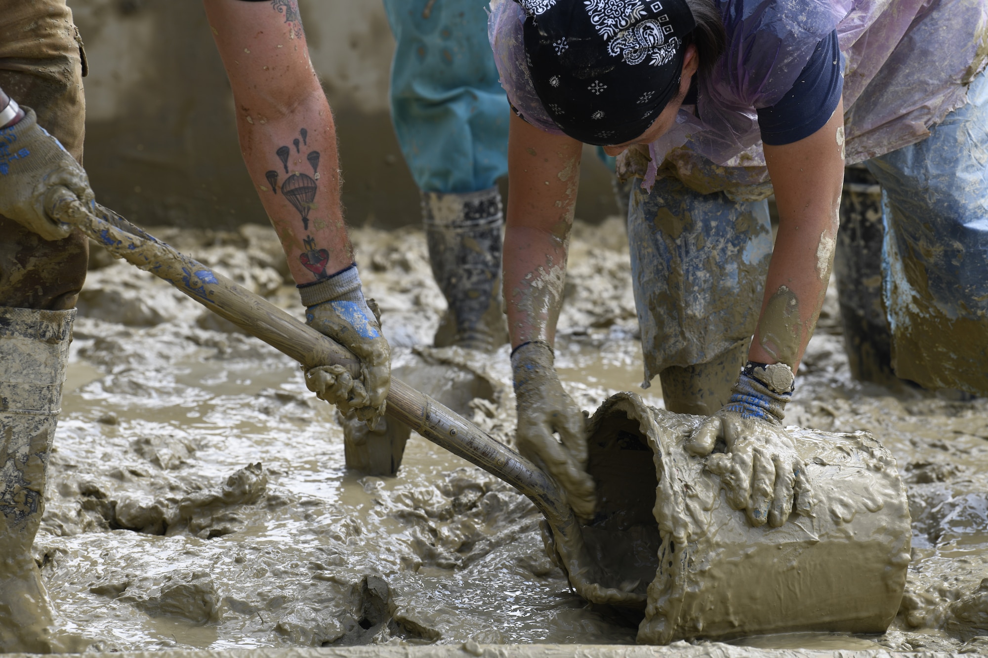 U.S. Air Force Tech. Sgt. Jack DeMato and Master Sgt. Myung McBride, recovery noncommissioned officers on a Defense POW/MIA Accounting Agency (DPAA) recovery team, shovel mud during operations in Nghe An province, Socialist Republic of Vietnam, Dec. 2, 2018.
