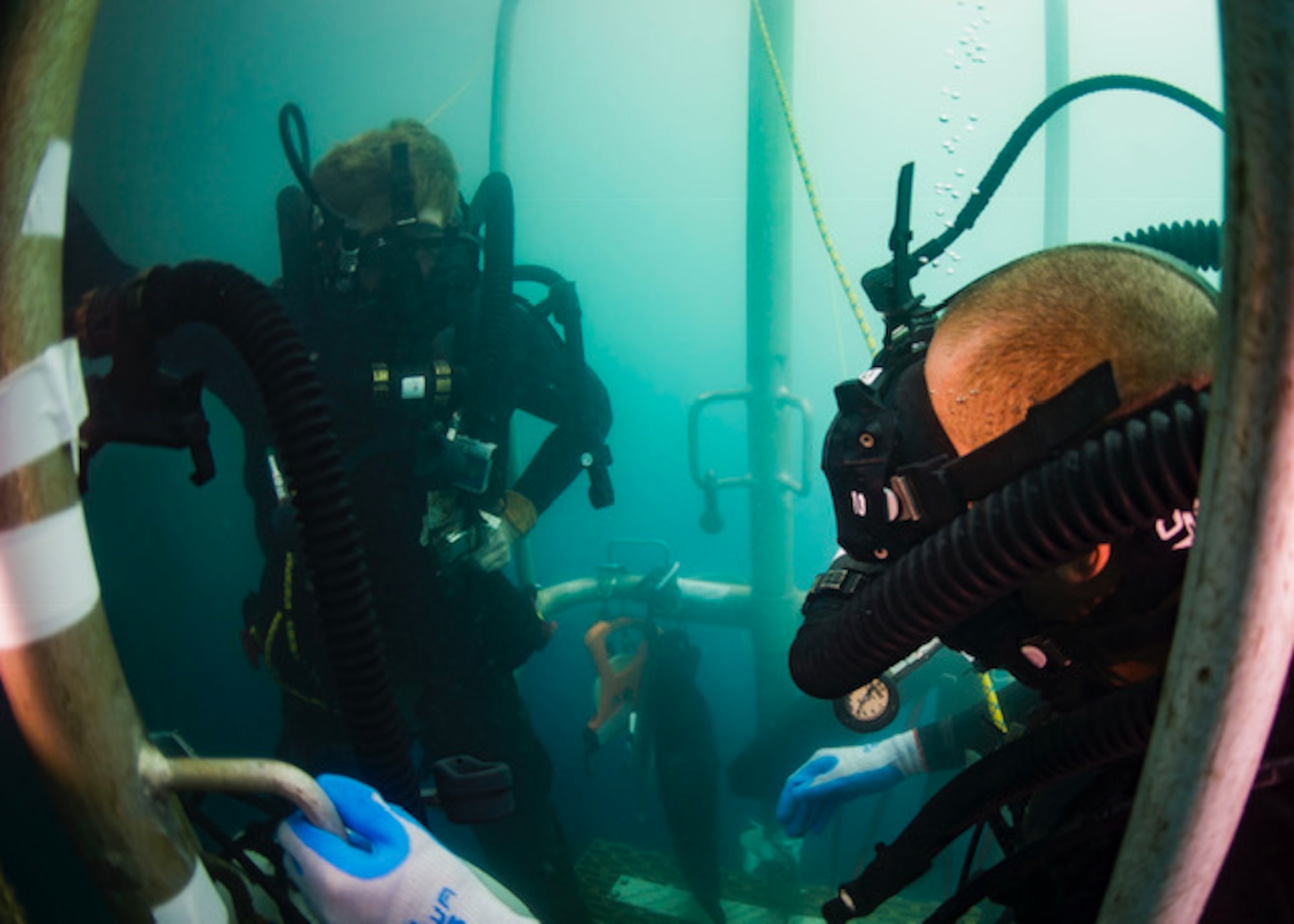 U.S. Navy Divers assigned to Mobile Diving and Salvage Company ONE-EIGHT embarked aboard USNS Salvor (T-ARS 52), wait on a diving stage during a two-hour decompression stop after diving to 240 feet off the coast of Madang, Papua New Guinea, Dec. 7, 2018.