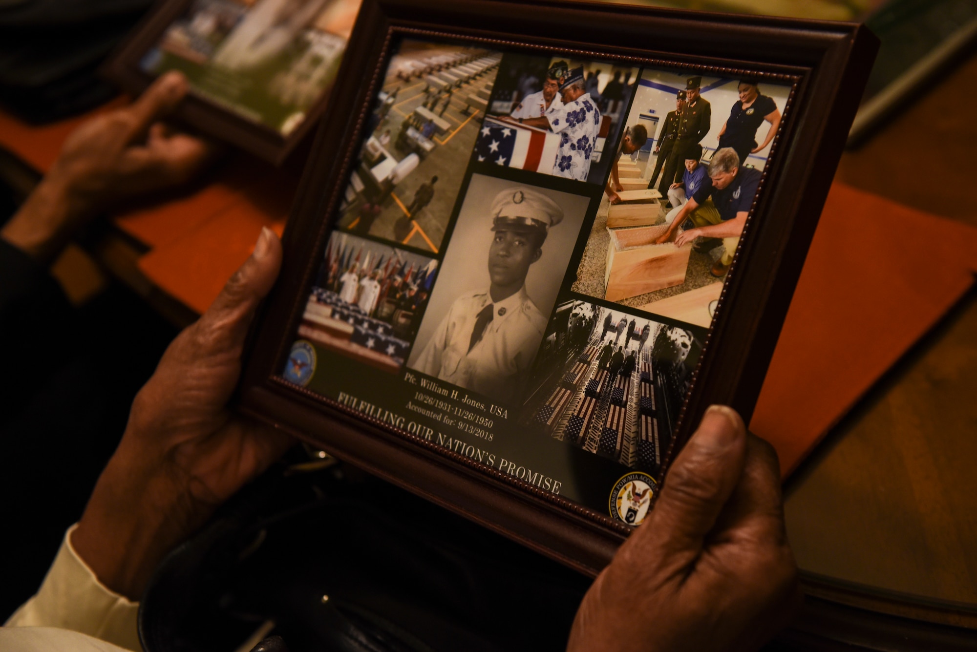 Ida Jones-Dickens holds a collage at her sister’s home in Rocky Mount, North Carolina, Nov. 15, 2018.