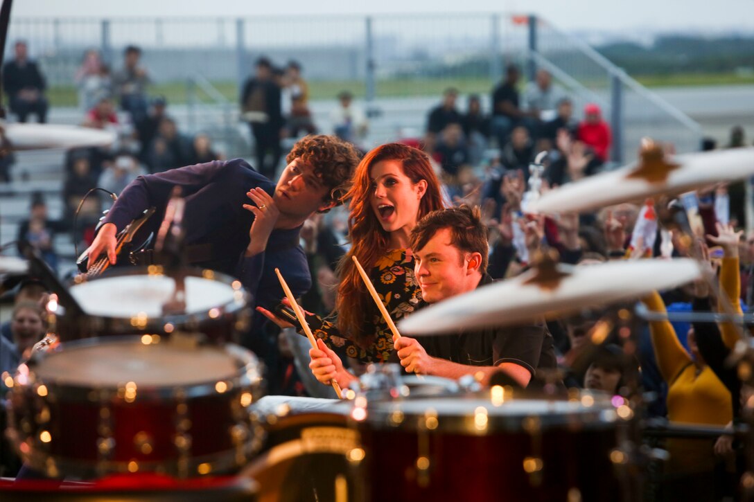 Members of Echosmith pose for a picture with the crowd  at the Futenma Flight Line Fair on Marine Corps Air Station Futenma, Mar. 10, 2019. The Futenma Flight Line Fair is an annual event that includes live music, games, and food vendors for attendees to enjoy. (U.S. Marine Corps photo by Lance Cpl. Marvin E. Lopez Navarro/Released)