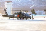Alaska National Guard members launch from Bryant Army Airfield on Joint Base Elmendorf-Richardson, Alaska, via a 1st Battalion, 207th Aviation Regiment, UH-60 Black Hawk helicopter with two pararescuemen from the 212th Rescue Squadron, 176th Wing, and an Army critical care flight paramedic from Detachment 2, Golf Company, 2nd General Support Aviation Battalion, 104th Regiment, on board to conduct continued search-and-rescue operations for a missing aircraft in the vicinity of Rainy Pass, March 12, 2019.