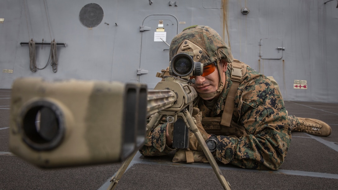 U.S. Marine Corps Sgt. Benjamin Westmoreland, a chief scout sniper with Weapons Company, Battalion Landing Team 3rd Battalion, 5th Marine Regiment, 11th Marine Expeditionary Unit, sights in behind a .50-caliber Special Applications Scoped Rifle aboard the San Antonio-class amphibious transport dock ship USS John P. Murtha. The Marines and Sailors of the 11th MEU are conducting routine operations as part of the Boxer Amphibious Ready Group in the eastern Pacific Ocean.
