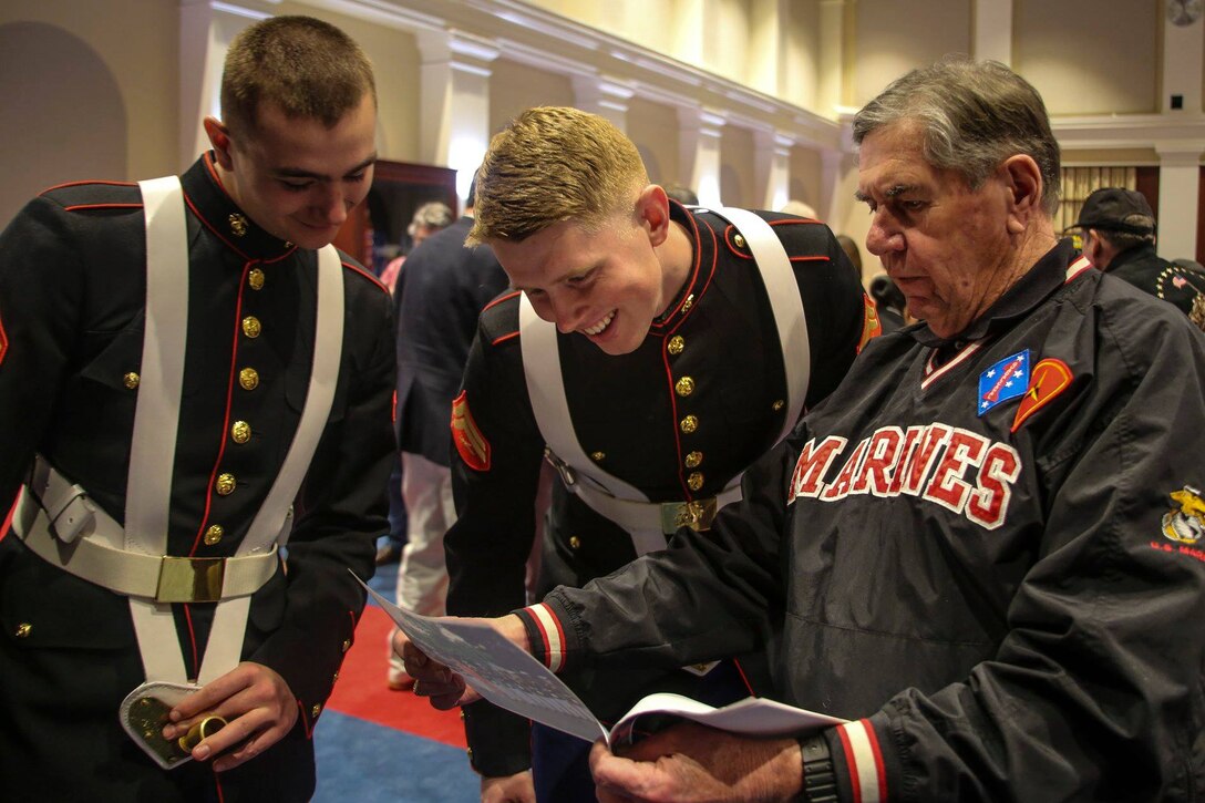 Marines with the Marine Corps Color Guard, Marine Barracks Washington D.C., interact with a veteran at the Barracks, Feb. 15, 2019. A ceremony was held for the Iwo Jima Association of America, including five Iwo Jima veterans, in honor of the 74th anniversary of the battle. Brigadier Gen. William J. Bowers, president, Marine Corps University, was the keynote speaker of the event. (U.S. Marine Corps photo by Cpl. Damon McLean/Released)