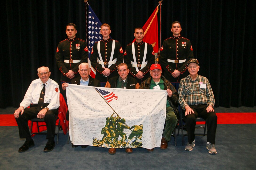 Marines with the Marine Corps Color Guard, Marine Barracks Washington D.C., pose for a photo with Iwo Jima veterans at the Barracks, Feb. 15, 2019. A ceremony was held for the Iwo Jima Association of America, including five Iwo Jima veterans, in honor of the 74th anniversary of the battle. Brigadier Gen. William J. Bowers, president, Marine Corps University, was the keynote speaker of the event. (U.S. Marine Corps photo by Cpl. Damon McLean/Released)