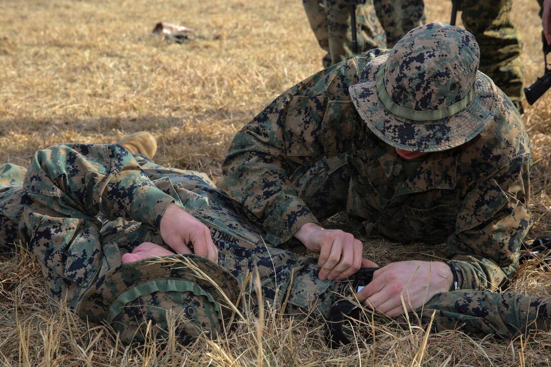 A Marine with Bravo Company, Marine Barracks Washington D.C., participates in a Combat Life Saving (CLS) class as a part of a field training exercise aboard Marine Corps Base Quantico, Quantico, Virginia, Feb. 7, 2019. Marines with Bravo Company, MBW, completed a three-day training evolution that consisted of a modified Table 5 qualification course (Combat Stress Shoot), live-fire, buddy-team rush drills, and a 203 IR shoot. (Official U.S. Marine Corps photo by Cpl. Damon McLean/Released)