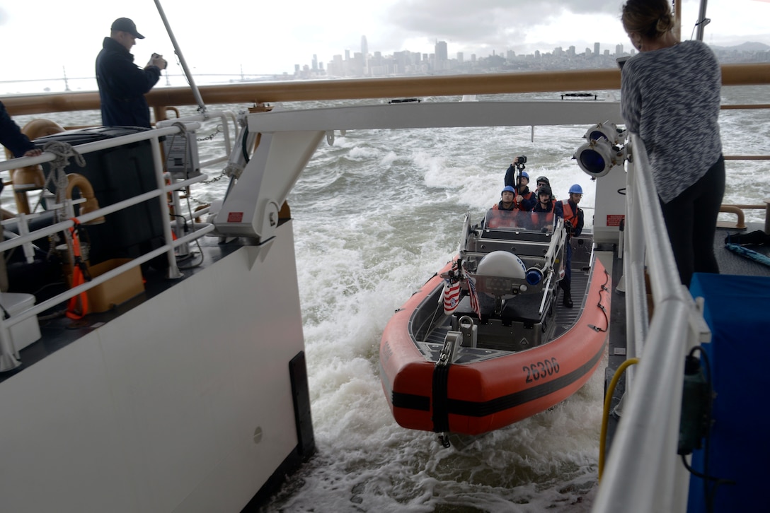 Crewmembers aboard a 26-foot Over the Horizon IV Cutter Boat enter the stern ramp of the Coast Guard Cutter Robert Ward after demonstrating the maneuverability of the OTH-IV in San Francisco Bay, Feb. 27, 2019.