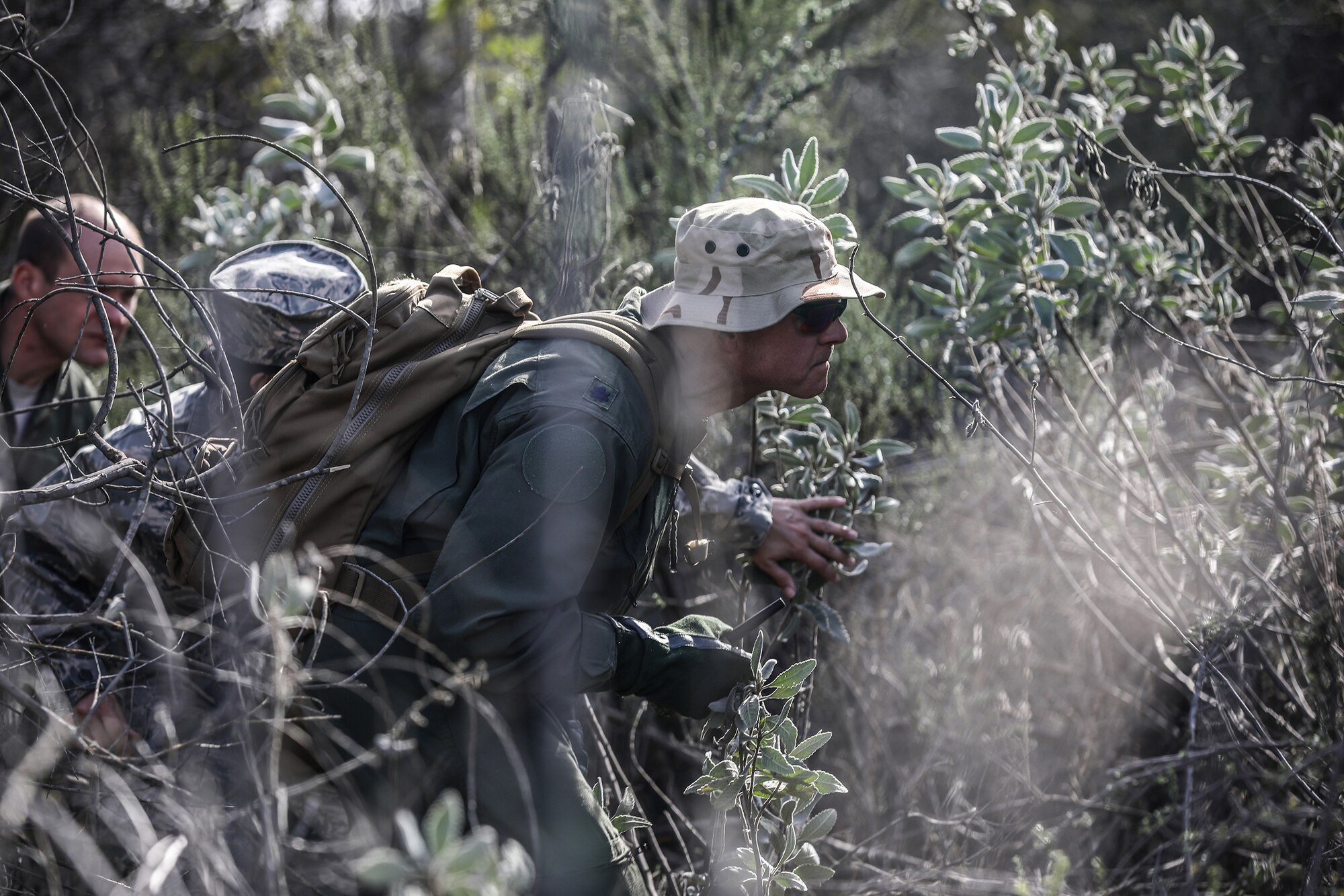 Lt. Col. Steven Shrader, 445th Operations Group deputy commander, takes cover during Evasion, Resistance and Escape (SERE) training at Naval Amphibious Base, Coronado, California, Jan. 20, 2019. Members of the 445th Airlift Wing Operations Group performed their annual training at Naval Amphibious Base, Coronado and Marine Corps Air Station Miramar near San Diego, California Jan. 18-27, 2019. The training included water survival, Survival, Evasion, Resistance and Evasion, and low altitude flying. (U.S. Air Force photo/Master Sgt. Patrick O’Reilly)