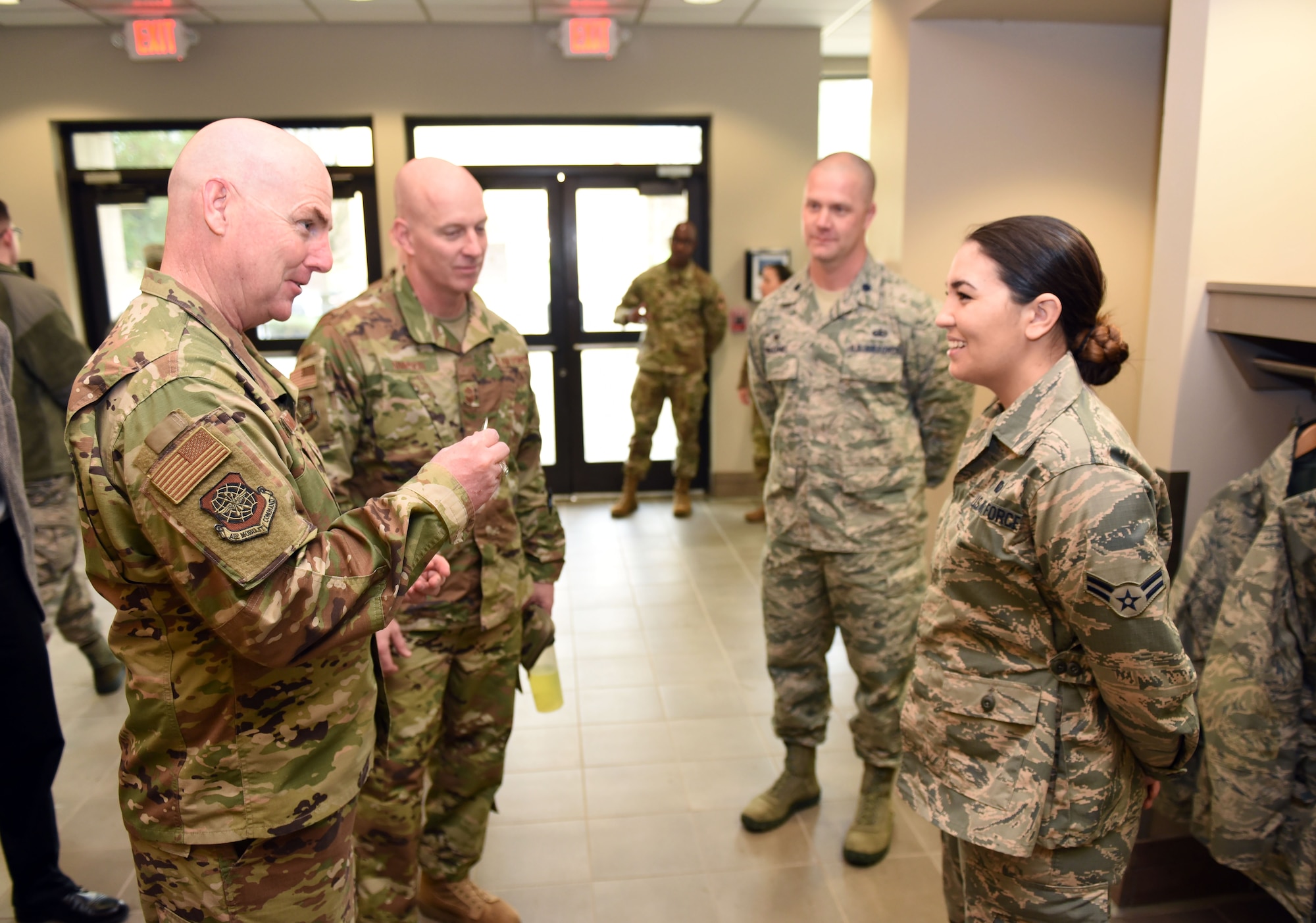 U.S. Air Force Maj. Gen. Sam Barrett, 18th Air Force commander, presents a coin to star performer U.S. Air Force Airman 1st Class Delaina McLeran, 60th Force Support Squadron food service specialist, during a visit to Travis Air Force Base, California, March 6, 2019, at the base's dining facility. Barrett, along with his wife, Kelly and U.S. Air Force Chief Master Sgt. Chris Simpson, 18th Air Force command chief, toured the base March 4 to 8 as part of a scheduled visit. (U.S. Air Force photo by Airman 1st Class Christian Conrad)