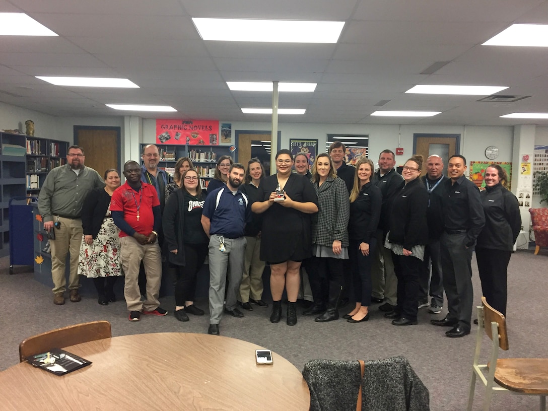 Anya Tassy, a second-year Leadership Experience Growing Apprenticeships Committed to Youth program Junior Apprentice displays her 2018 LEGACY Student of the Year award after receiving it surrounded by Wright-Patterson Air Force Base Educational Outreach and Fairborn High School staff Nov. 15, 2018. The LEGACY program is in need of mentors for the coming summer with an application deadline of March 29. (Courtesy photo)