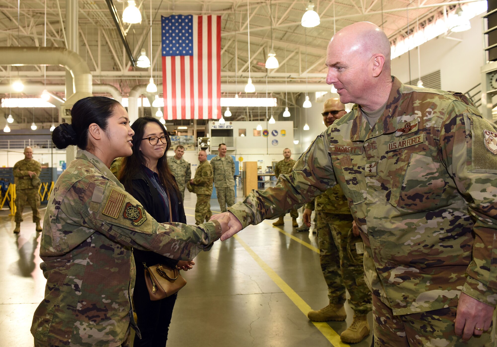 U.S. Air Force Maj. Gen. Sam Barrett, 18th Air Force commander, presents a coin to star performer U.S. Air Force Airman 1st Class Kristyn Fernando, 60th Maintenance Squadron fuel system apprentice, during a visit to Travis Air Force Base, California, March 5, 2019. Barrett, along with his wife, Kelly and U.S. Air Force Chief Master Sgt. Chris Simpson, 18th Air Force command chief, toured the base March 4 to 8 as part of a scheduled visit. (U.S. Air Force photo by Airman 1st Class Christian Conrad)