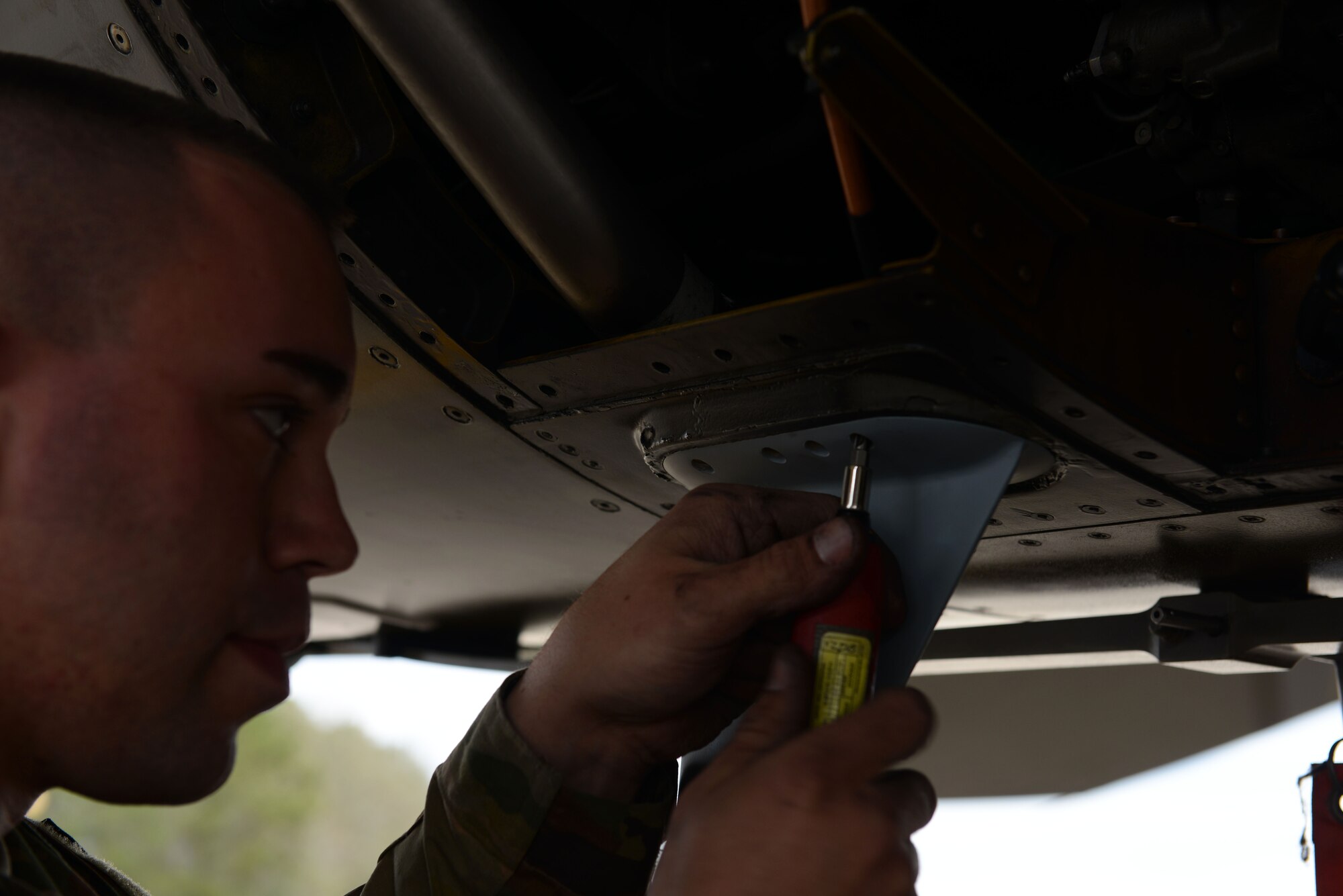 U.S. Air Force Staff Sgt. Jeremy Gonzalez, 20th Aircraft Maintenance Squadron, 77th Aircraft Maintenance Unit avionics specialist, unscrews a panel on an F-16CJ Fighting Falcon at Shaw Air Force Base, S.C., March 11, 2019.