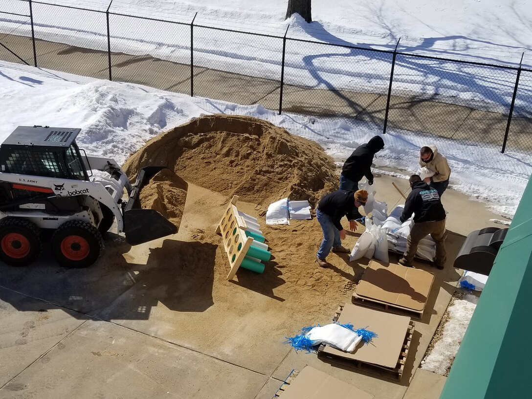 crews fill sandbags