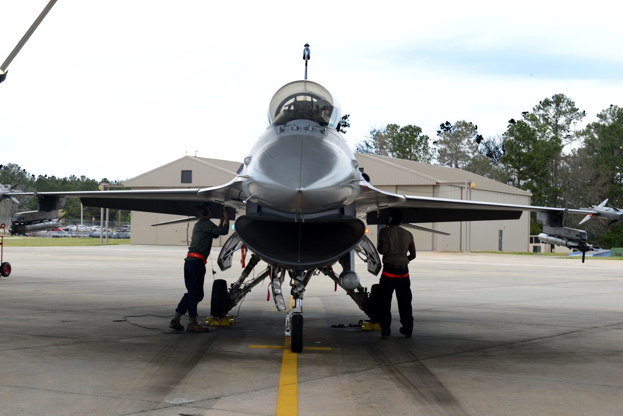 U.S. Air Force 20th Aircraft Maintenance Squadron Airmen guide a pilot, as he lands, ensuring he is safe to get out of his aircraft at Shaw Air Force Base, S.C., March 11, 2019.