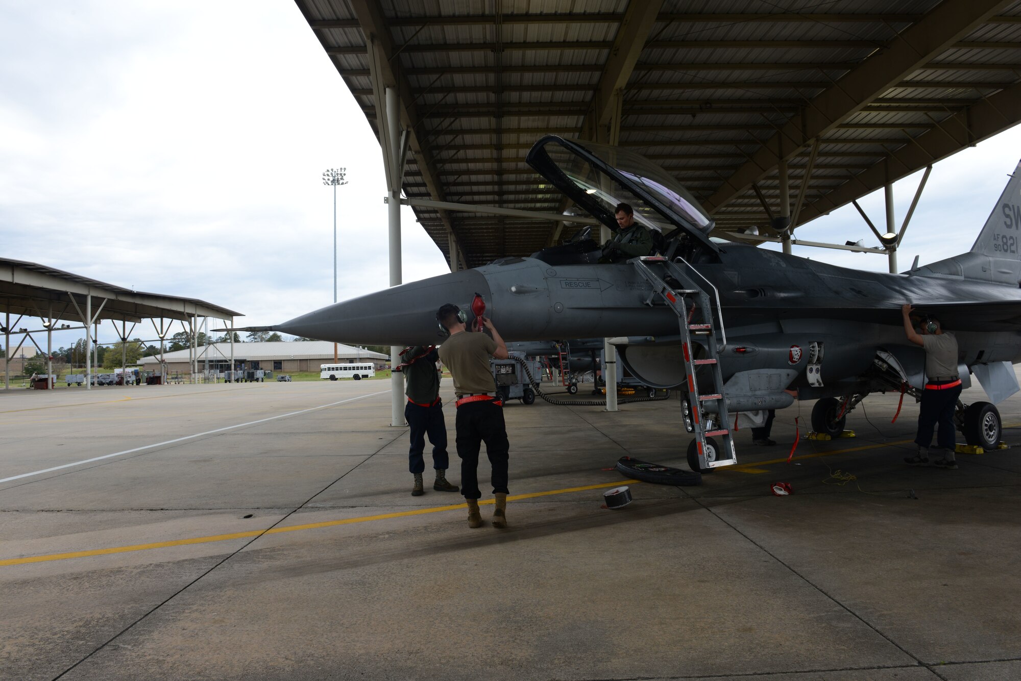 U.S. Air Force Senior Airman Jacob Leighton, 20th Aircraft Maintenance Squadron (AMXS), 77th Aircraft Maintenance Unit (AMU) tactical aircraft maintainer, left, alongside, Airman 1st Class Austin Deney 20th AMXS, 77th AMU avionics specialist, right, secure an F-16CJ Fighting Falcon, as a pilot prepares to exit his jet, at Shaw Air Force Base, S.C., March 11, 2019.