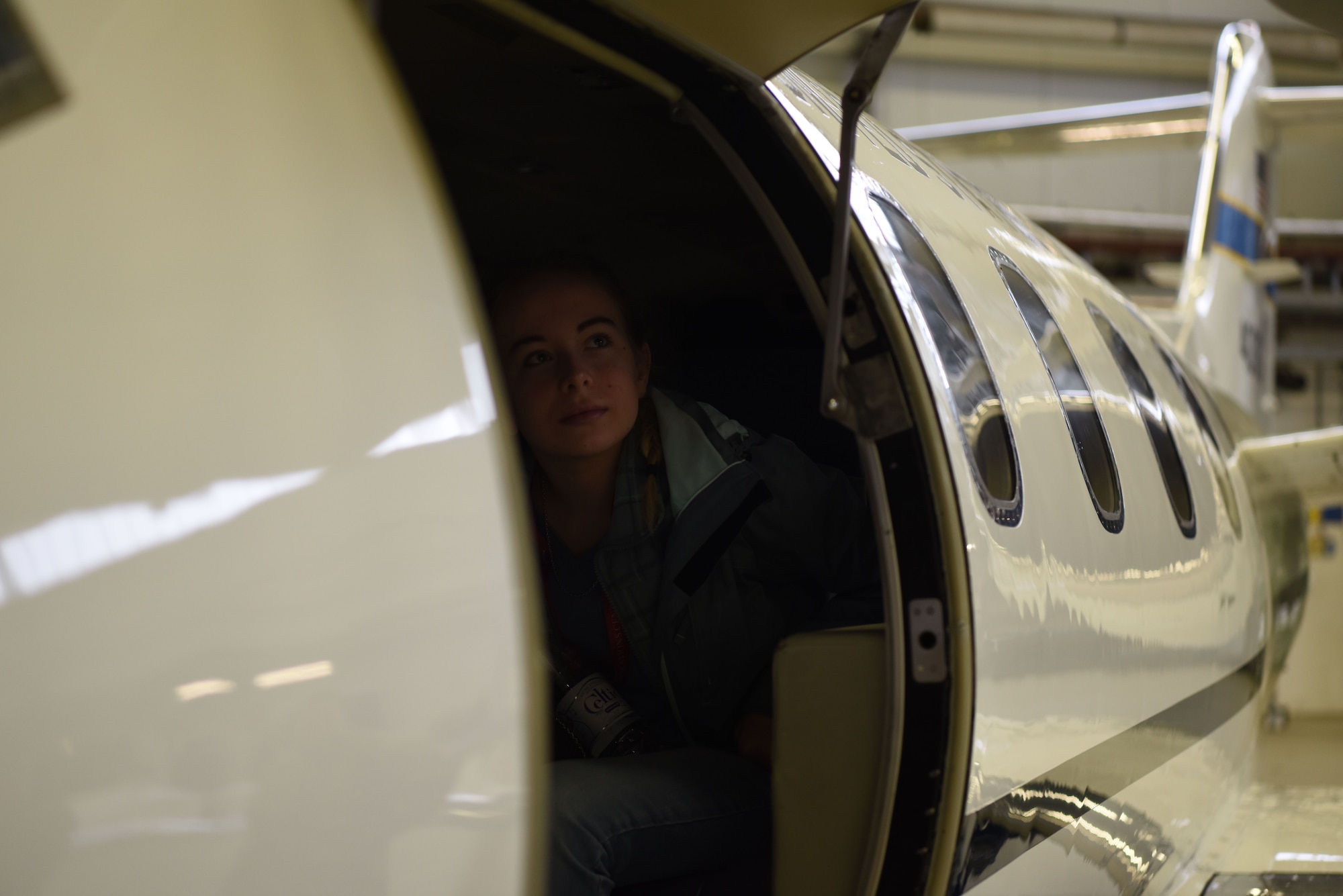 Chloe Perrow, Ramstein High school student sits in a static display of a C-21 Learjet at a Young Women in Aviation Day event on Ramstein Air Base, Germany, March, 9, 2019. A group of approximately 100 students from various schools around the Kaiserslautern Military Community came to Ramstein to learn about the ranging careers of women working in the aviation field.