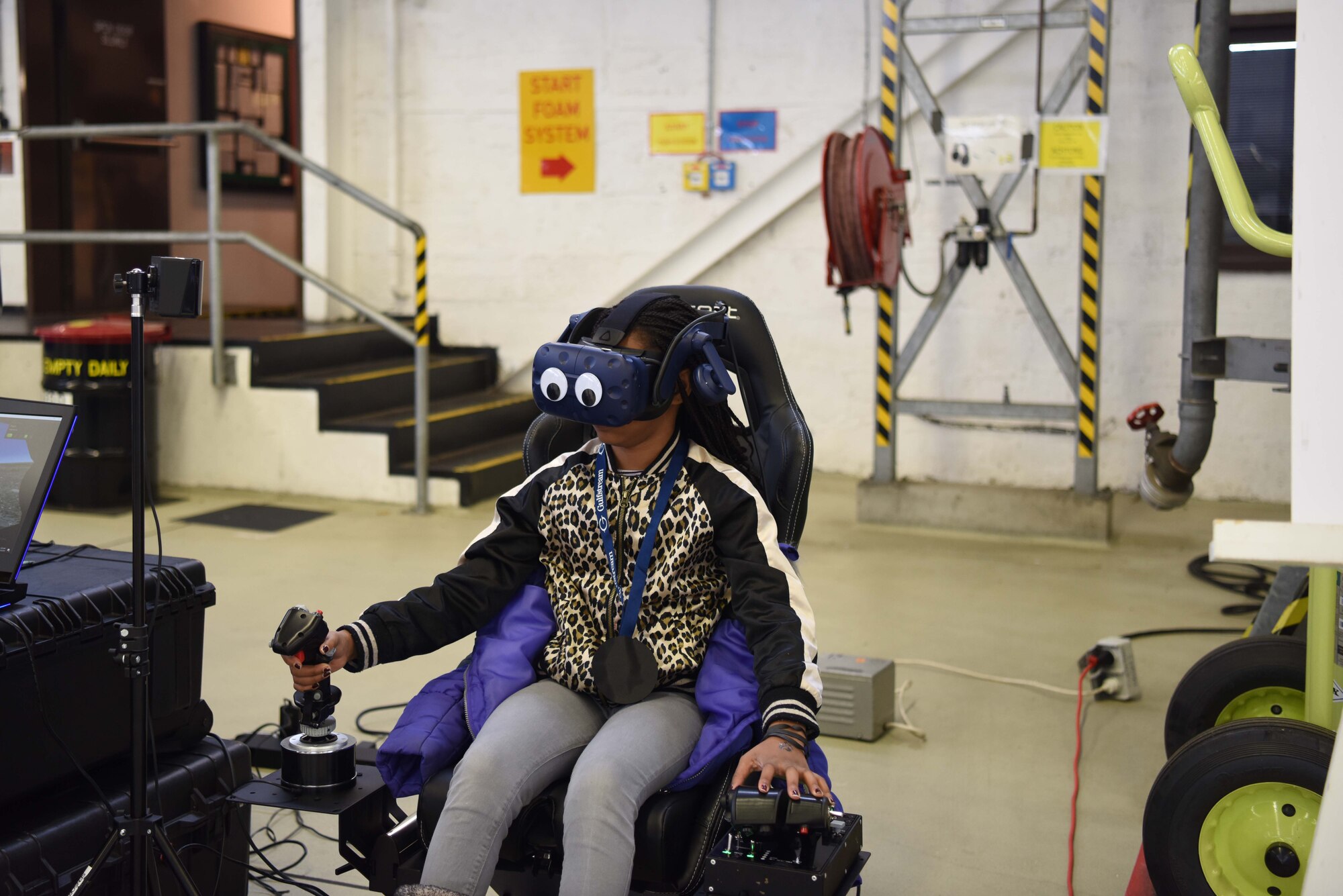 Kimahya King, Kaiserslautern Military Community student uses a flight simulator during Young Women in Aviation Day at Ramstein Air Base, Germany, March, 9, 2019. King was able to experience one way pilots train for real-world missions.