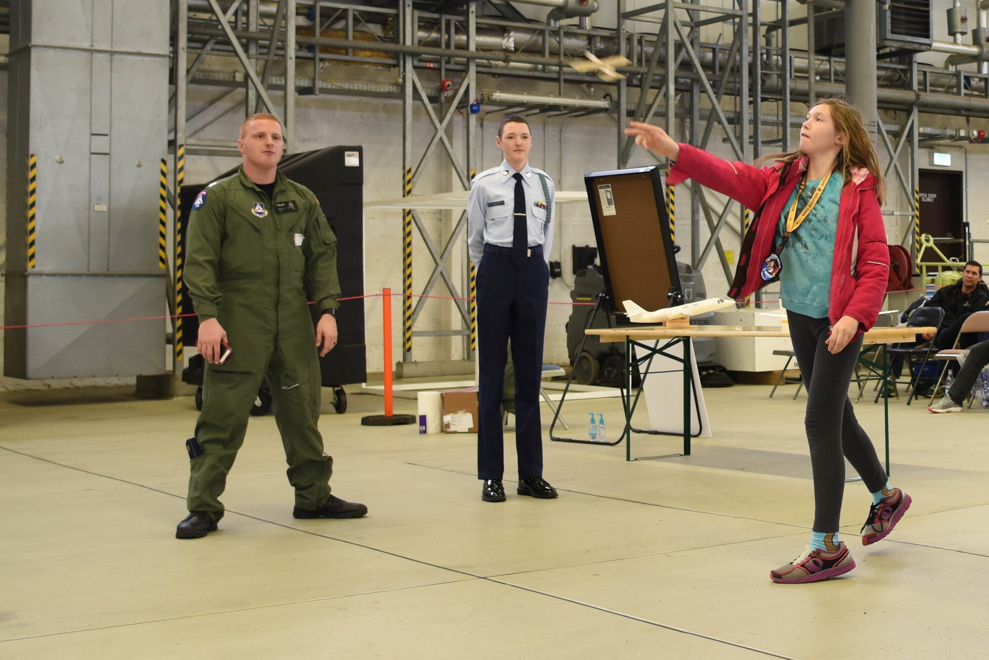 A Kaiserslautern Military community School student flies a paper plane during a Young Women in Aviation Day event on Ramstein Air Base, Germany, March, 9, 2019. Students eagerly lined up to be able to build and fly their own paper planes.