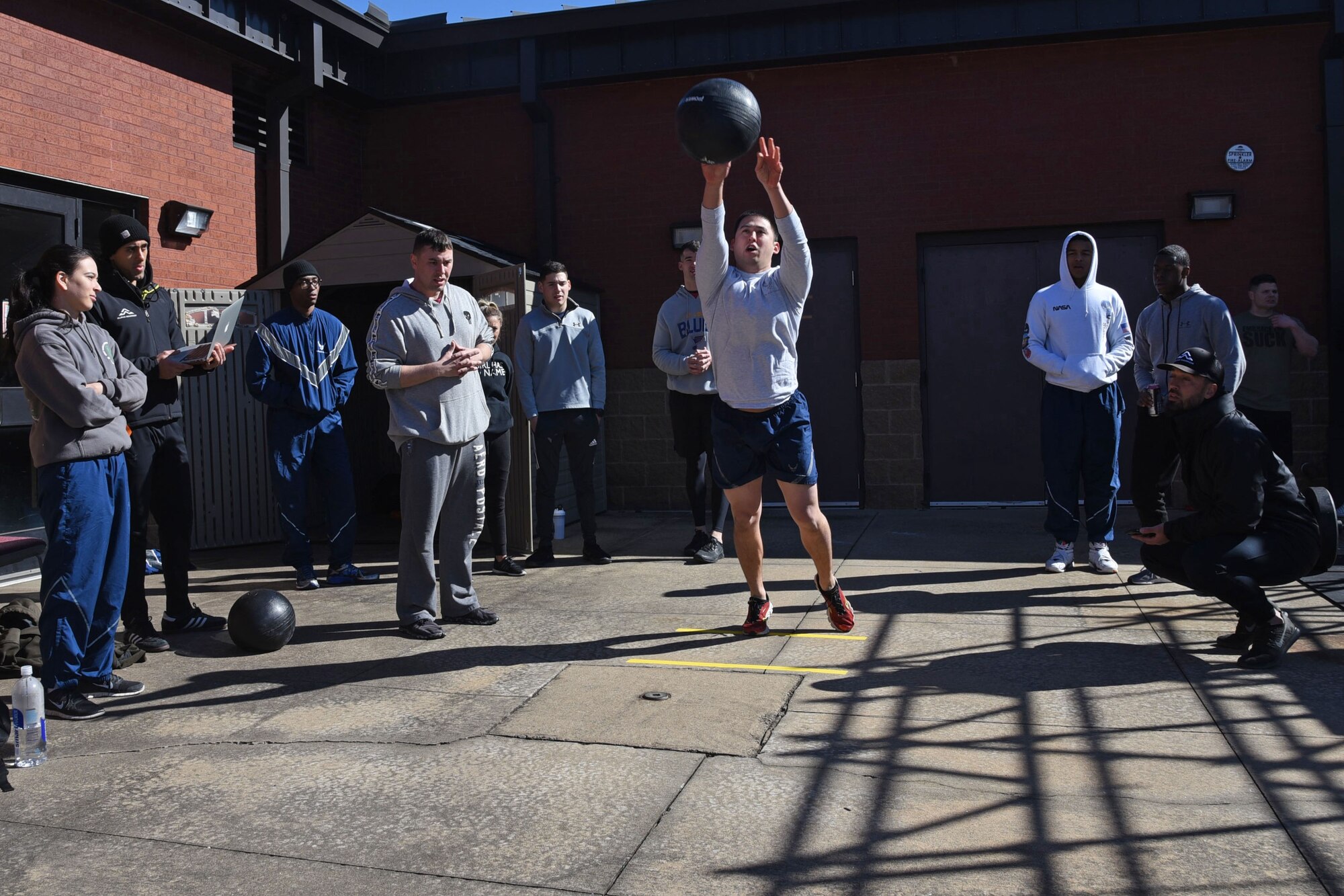 An Airman throws a medicine ball