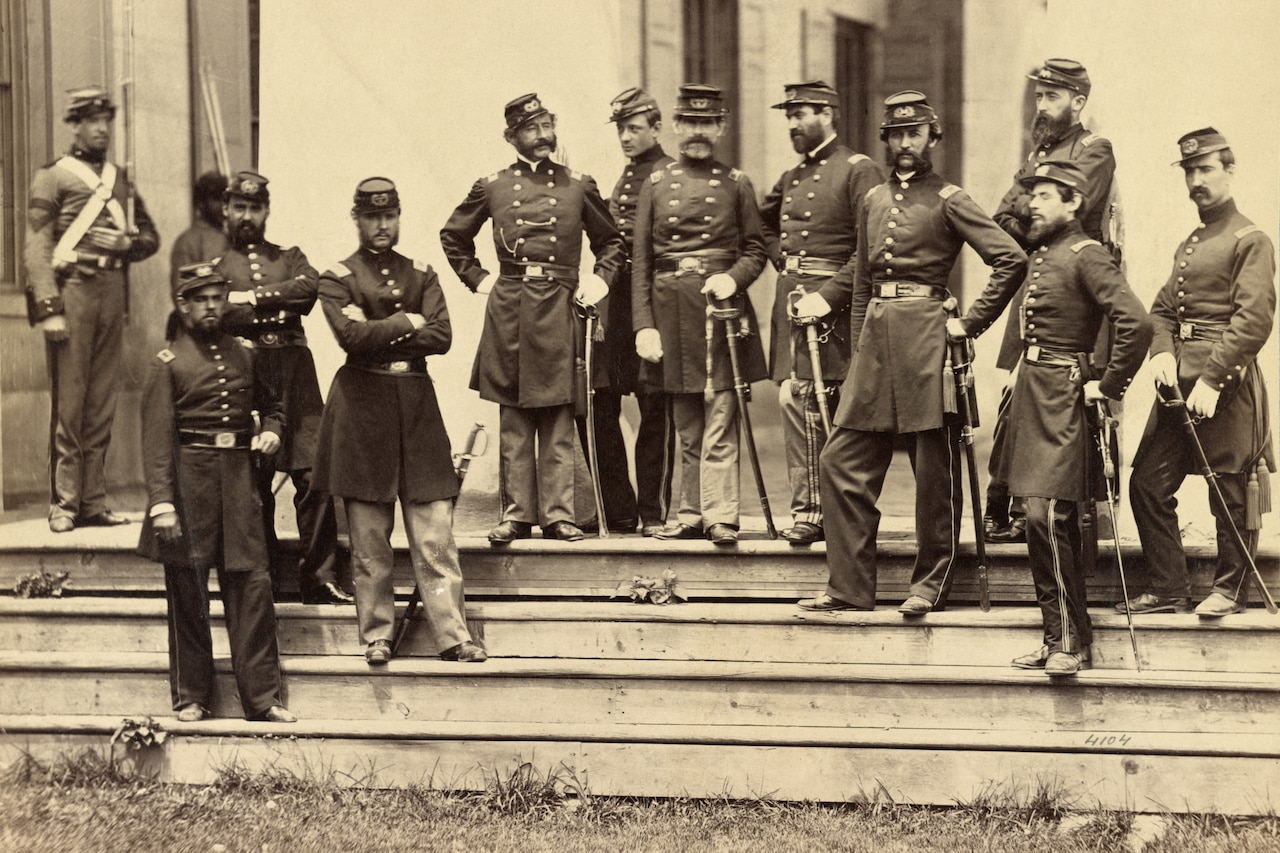 Soldiers stand in front of a mansion.