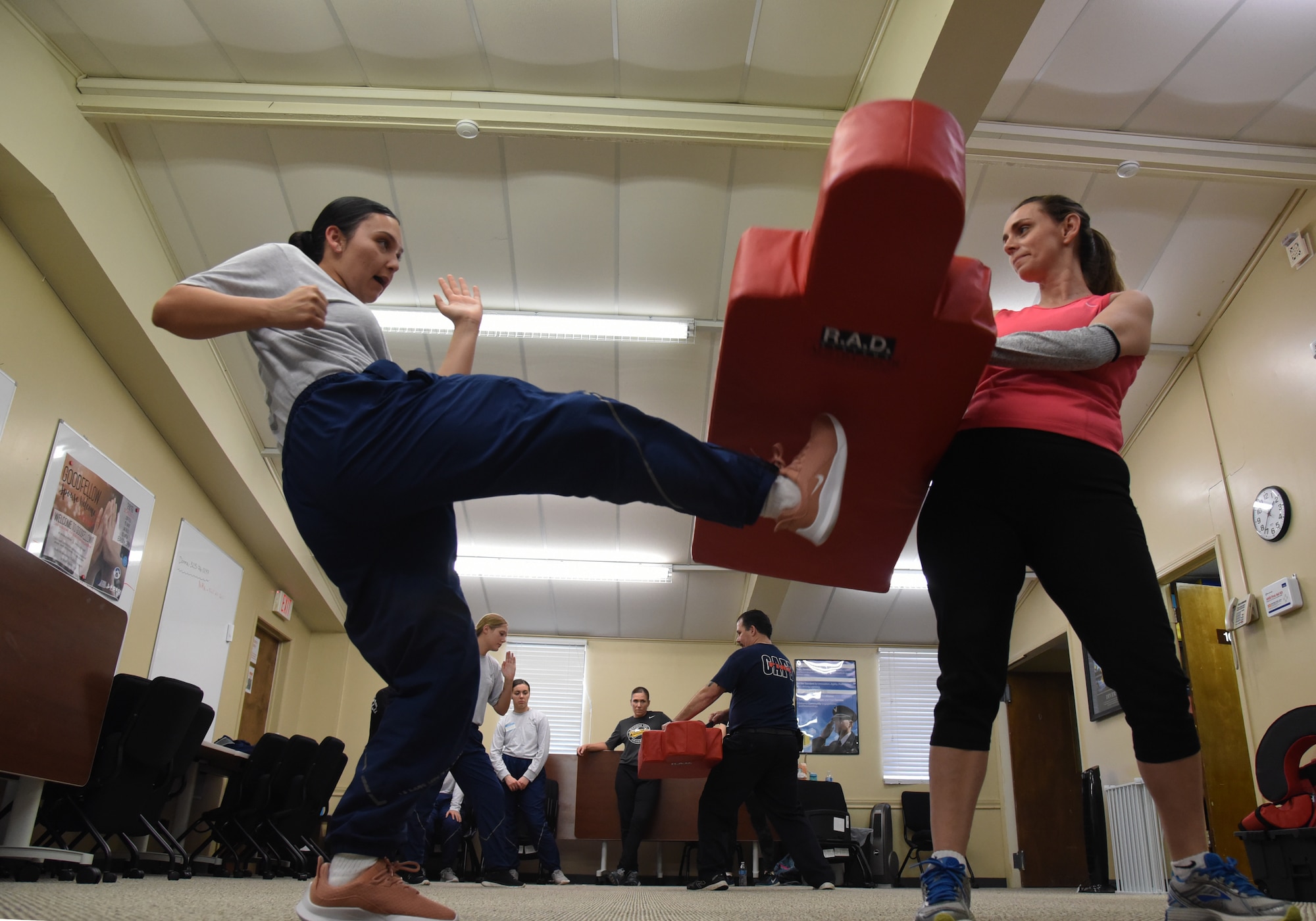 U.S. Air Force Airman 1st Class Mariscea Valdivia, 315th Training Squadron student, learns to kick from her knee during a women’s self-defense class in the Goodfellow Resiliency Center, at Goodfellow Air Force Base, Texas, March 8, 2019. The kick was designed as self-defense to hit the pelvic or groin area of an aggressor. (U.S. Air Force photo by Airman 1st Class Abbey Rieves/ Released)