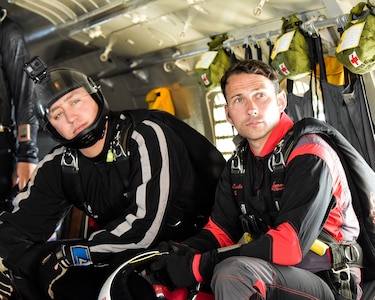 Fort Benning Silver Wings and Red Devil Soldiers on a plane preparing for a jump at 13,000 altitude. These teams use joint training opportunities to learn and grow as Soldiers and parachute team.