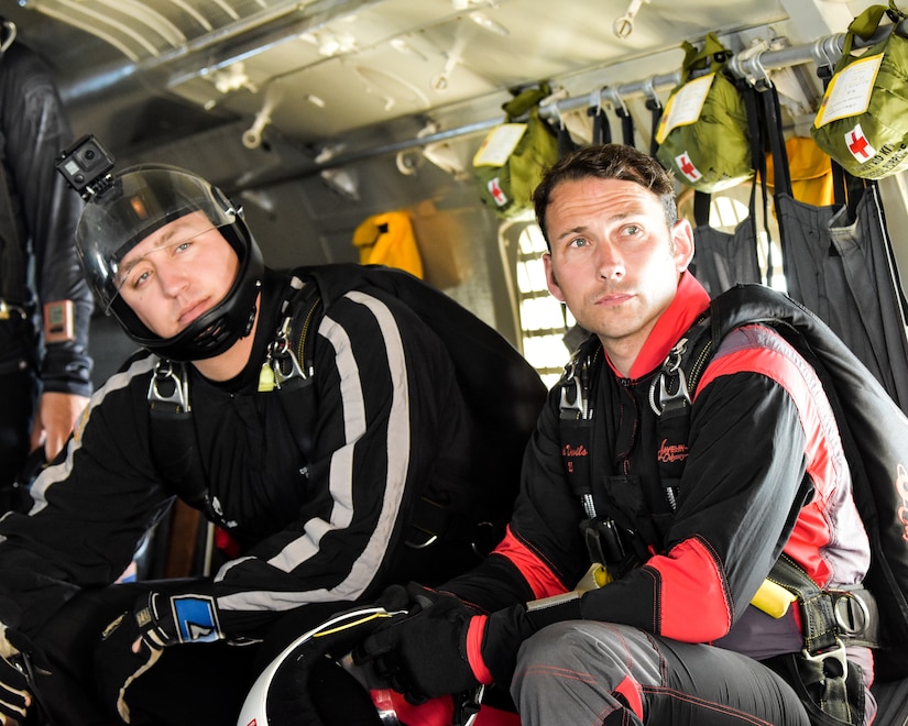 Fort Benning Silver Wings and Red Devil Soldiers on a plane preparing for a jump at 13,000 altitude. These teams use joint training opportunities to learn and grow as Soldiers and parachute team.