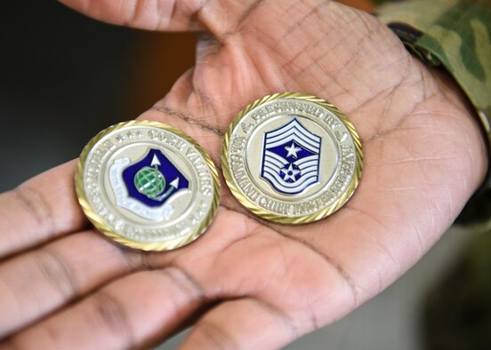 U.S. Air Force Chief Master Sgt. Diena Mosely, 30th Space Wing command chief, presents coins to 12 of the 30th Civil Engineer Squadron Airmen, March 12, 2019, at Vandenberg Air Force Base, Calif. The Airmen worked hard day and night last weekend after a storm hit Vandenberg AFB, and now the 30th Space Wing commander and command chief are recognizing their hard work. (U.S. Air Force photo by Airman 1st Class Aubree Milks)