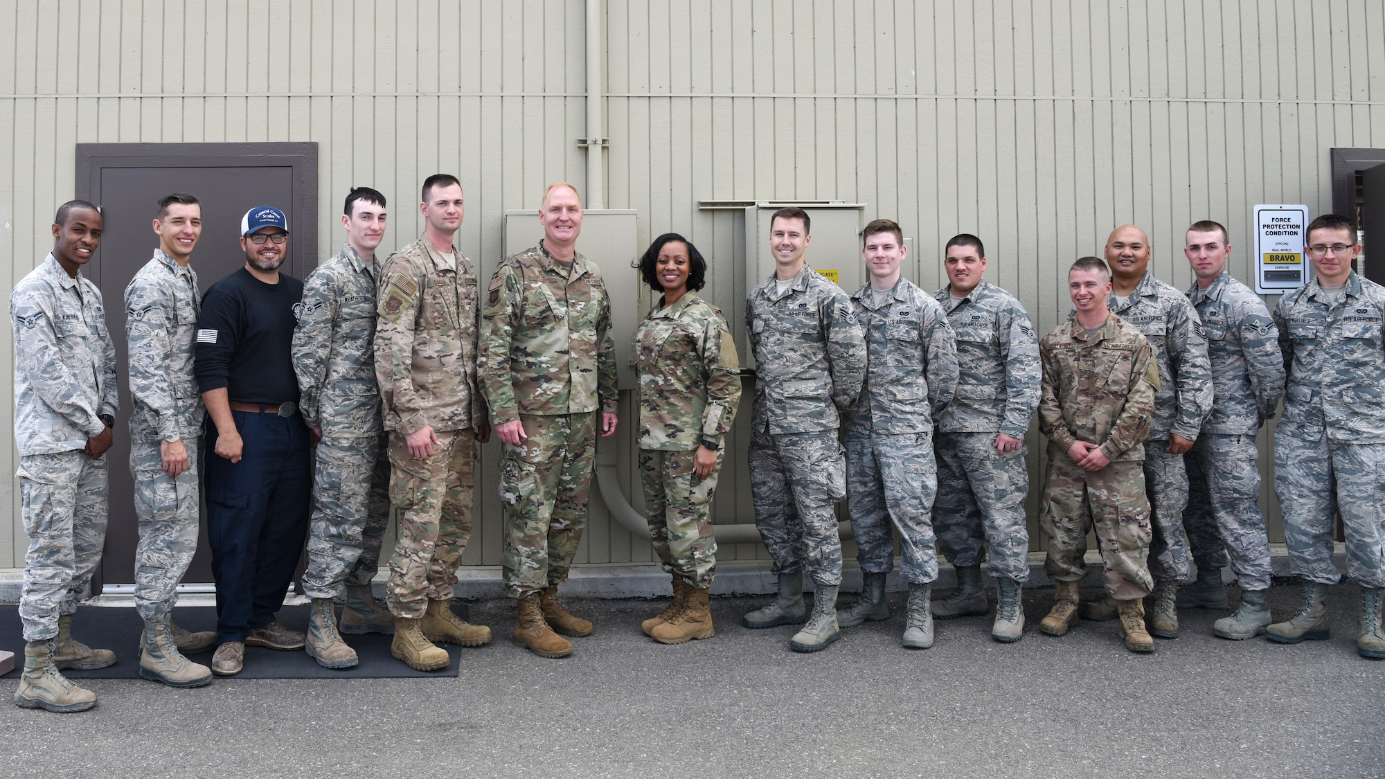 U.S. Air Force Col. Michael Hough, 30th Space Wing commander, and Chief Master Sgt. Diena Mosely, 30th Space Wing command chief, take a group photo with the 12 30th Civil Engineer Squadron Airmen March 12, 2019, at Vandenberg Air Force Base, Calif. Hough and Mosely both presented their coins to the Airmen for their tedious and tireless work when a storm hit Vandenberg AFB, March 8, 2019.