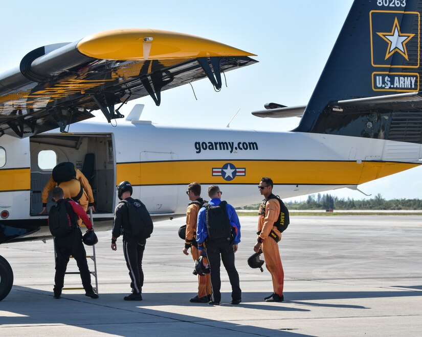 Soldiers from multiple teams prepare to board the Golden Knights plane for another practice jump.