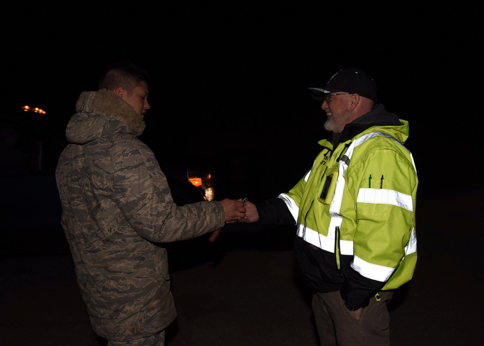 Airman from the 576th Flight Test Squadron hands over the launch facility keys to Jason Porter, 30th Space Wing Safety Office operation safety technician Feb. 5, 2019 at Vandenberg Air Force Base, Calif. Porter will report back to the fallback site and continue his other duties prior to launch. (U.S. Air Force photo by Airman 1st Class Aubree Milks)
