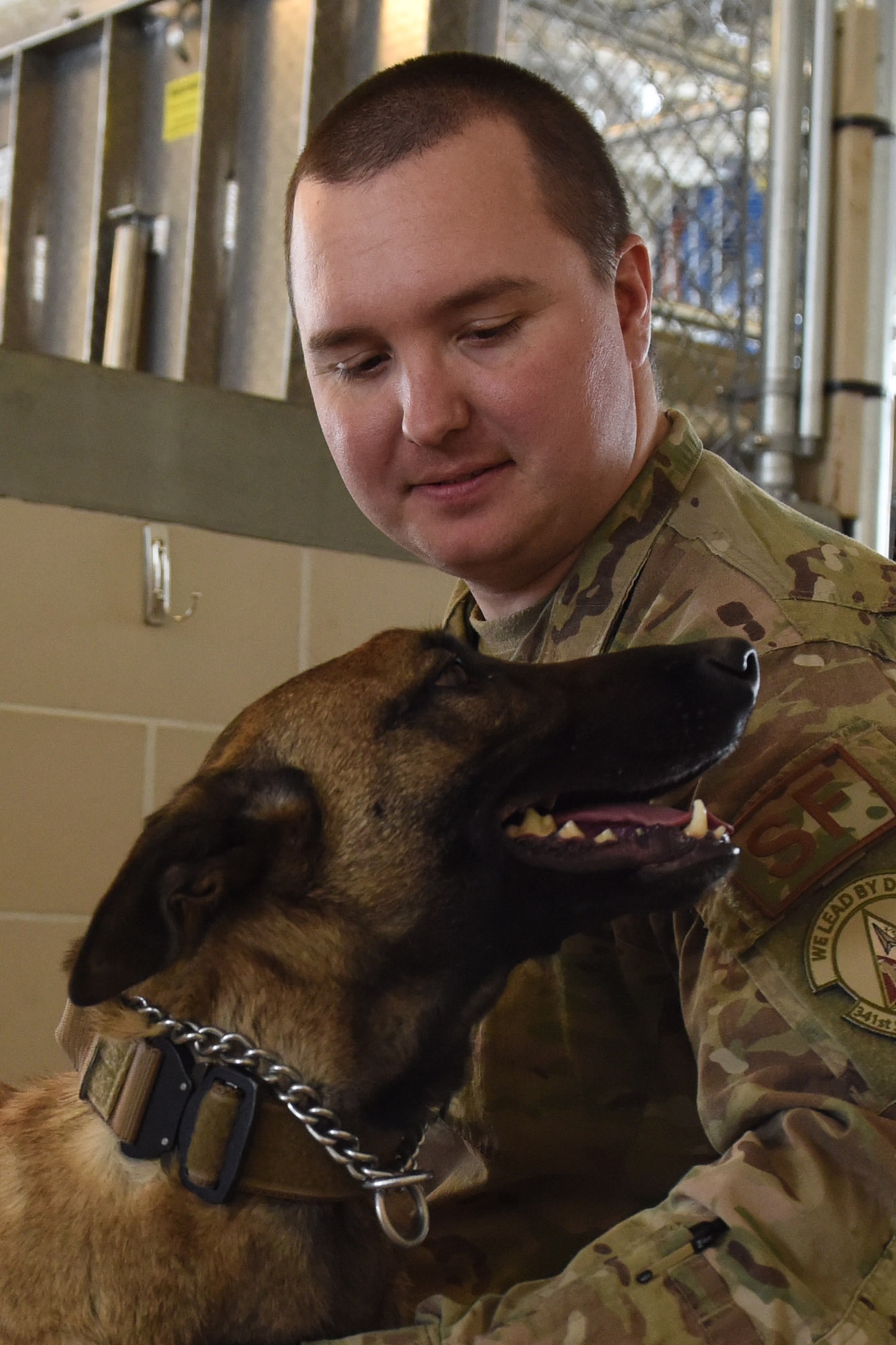 Staff Sgt. Christopher Hotine, 341st Security Forces Squadron military working dog handler, and MWD, Ffarah, pose for a photo March 1, 2019, at Malmstrom Air Force Base, Mont.