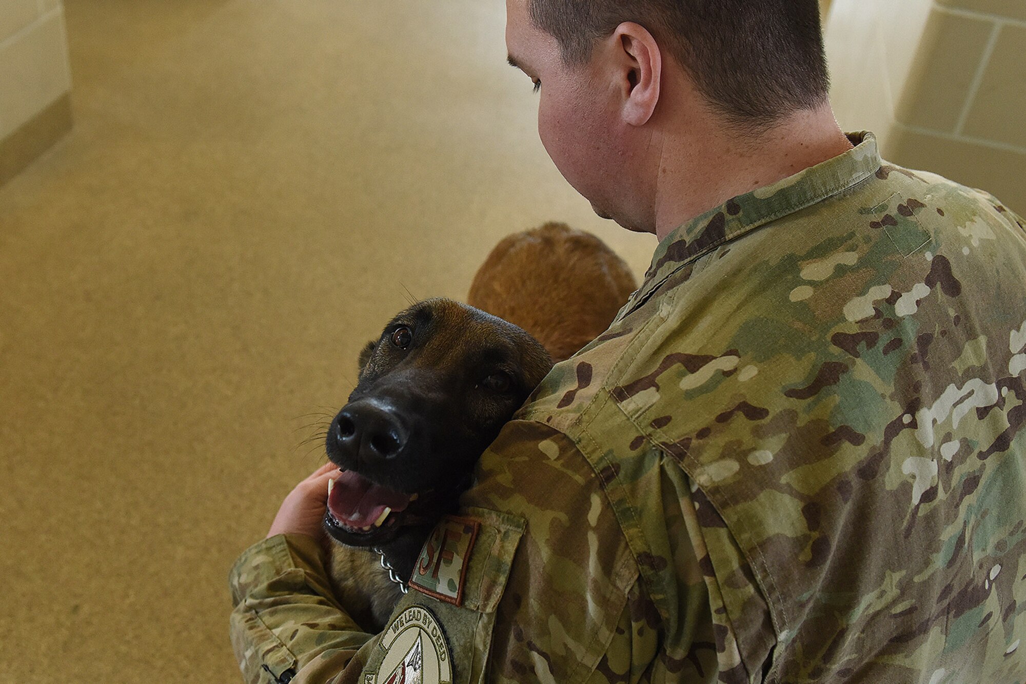 Staff Sgt. Christopher Hotine, 341st Security Forces Squadron military working dog handler, and MWD, Ffarah, pose for a photo March 1, 2019, at Malmstrom Air Force Base, Mont.