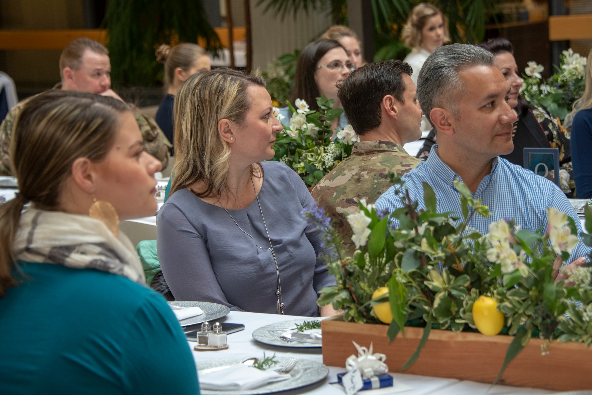 Audience members listen to remarks given at the Key Spouse Recognition event at the 60th Maintenance Group atrium, Feb. 8, 2019 at Travis Air Force Base, California. The Key Spouse Program is an Air Force-wide volunteer program that builds and fosters support for military families through outreach education events and providing families a link to leadership.(U.S. Air Force photo by Heide Couch)
